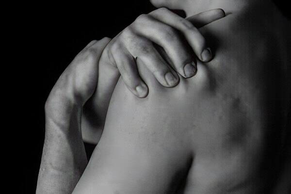 image of a person grabbing their left shoulder