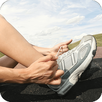 image of person putting on a shoe.