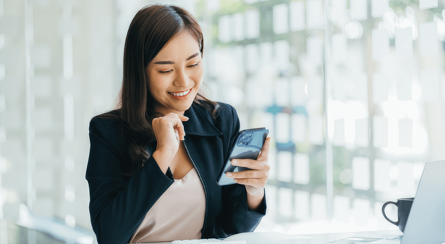 Woman smiles at her phone